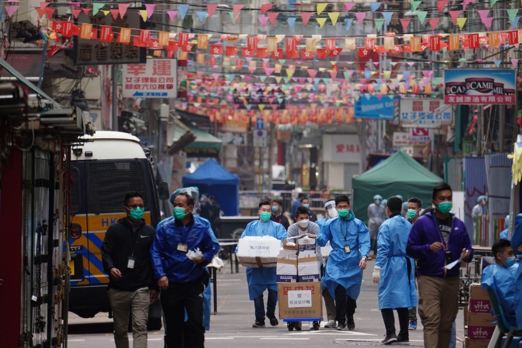 Hong Kong government staff arrive with supplies on the second day of the localised lockdown in Yau Ma Tei, on January 24. Photo: Robert Ng