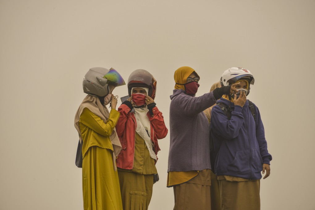 Indonesians in Aceh province battle a thick haze caused by smog-belching forest fires in the region. Photo: AFP