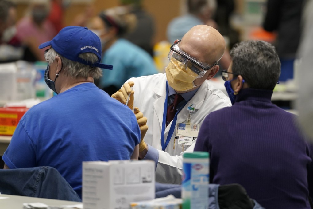 A patient gets the first of two doses of the Pfizer vaccine for Covid-19 in Seattle on Sunday. Photo: AP