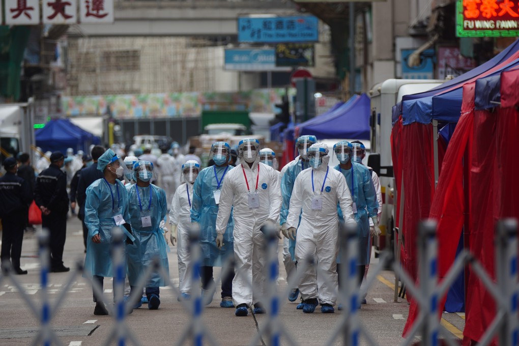 Civil servants, police and members of the disciplined services stand guard at the restricted area in Yau Tsim Mong on Sunday. Photo: Sam Tsang