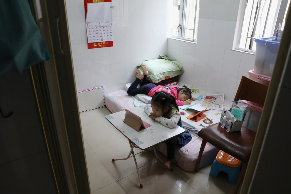 Two children do their homework in a subdivided flat in Tsuen Wan. Photo: K.Y. Cheng