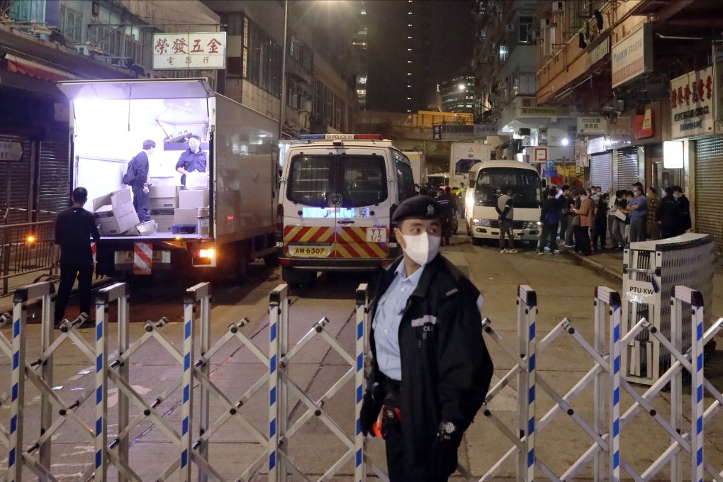 A police officer stands guard after 12 residential buildings in Yau Ma Tei were placed under lockdown. Photo: K.Y. Cheng