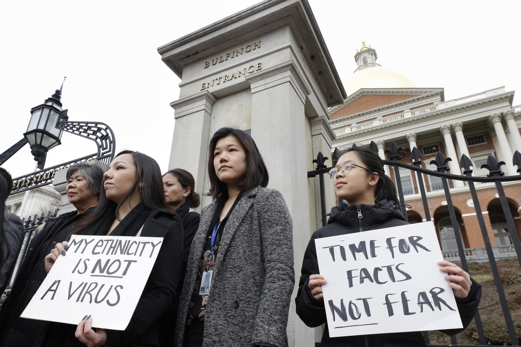 Members of Boston’s Asian-American community stand at the steps of the Statehouse in March 2020 to protest against racism, fearmongering and misinformation amid the coronavirus pandemic. Photo: AP
