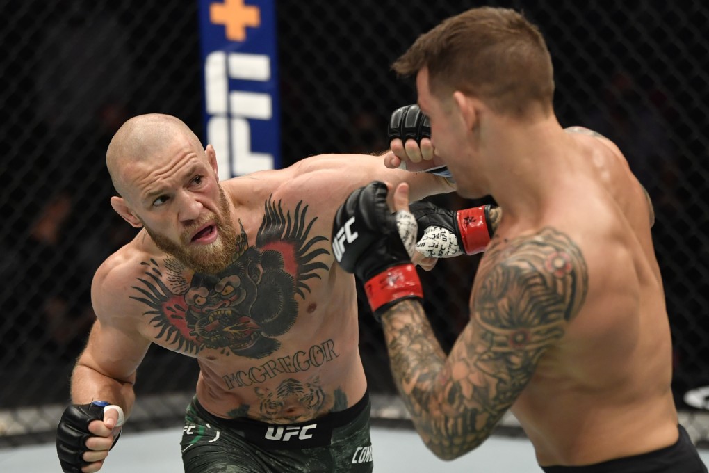 Conor McGregor punches Dustin Poirier in their lightweight main event at UFC 257. Photo: Jeff Bottari/Zuffa LLC