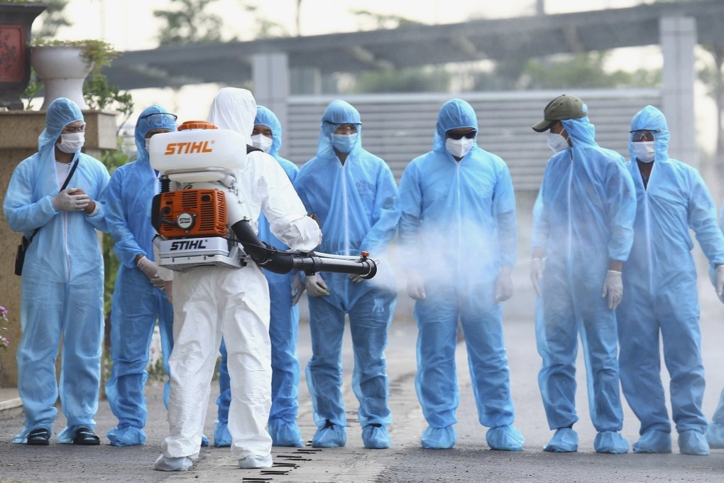 A Vietnamese health worker disinfects Covid-19 patients at the national hospital of tropical diseases in Hanoi last year. Vietnam, with fewer than 1,600 recorded cases, has been praised for its coronavirus response. Photo: VNA via AP
