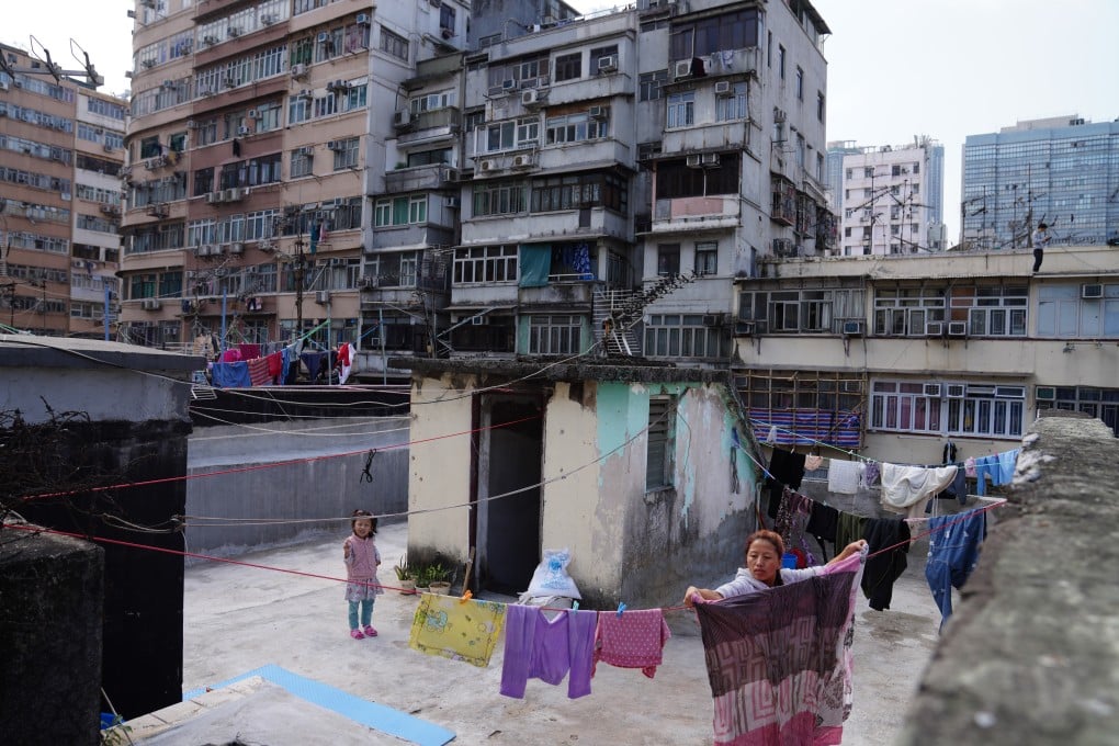 A woman dries clothes on a rooftop near the lockdown zone in the Yau Tsim Mong district of Hong Kong on January 24. Photo: Sam Tsang