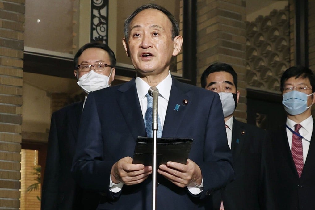 Japanese Prime Minister Yoshihide Suga speaks to reporters at his official residence in Tokyo in the early hours of Thursday morning. Photo: Kyodo
