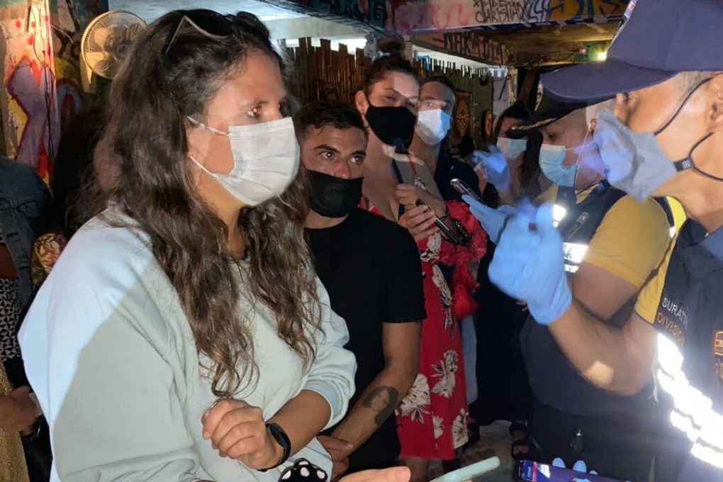 Thai officials raid a party at a bar in southern Thailand on Wednesday. Photo: Police Investigation Team of Surat Thani Immigration via AP