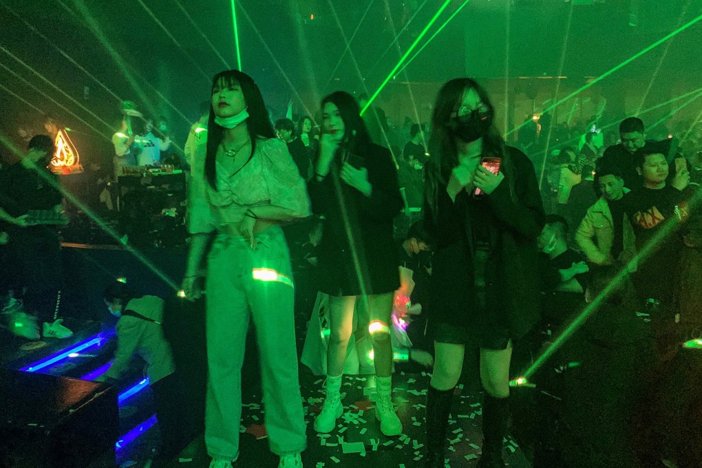 Face masks are obligatory at the door of Wuhan’s nightclubs but people take them off to chat with friends, dance or smoke. Photo: AFP