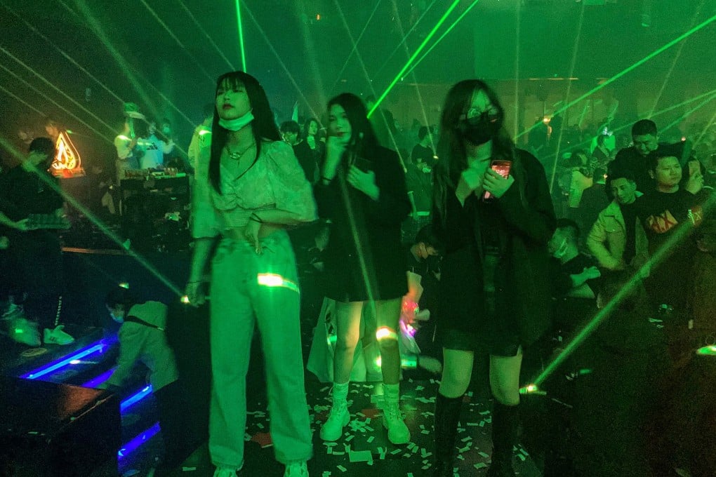 Face masks are obligatory at the door of Wuhan’s nightclubs but people take them off to chat with friends, dance or smoke. Photo: AFP