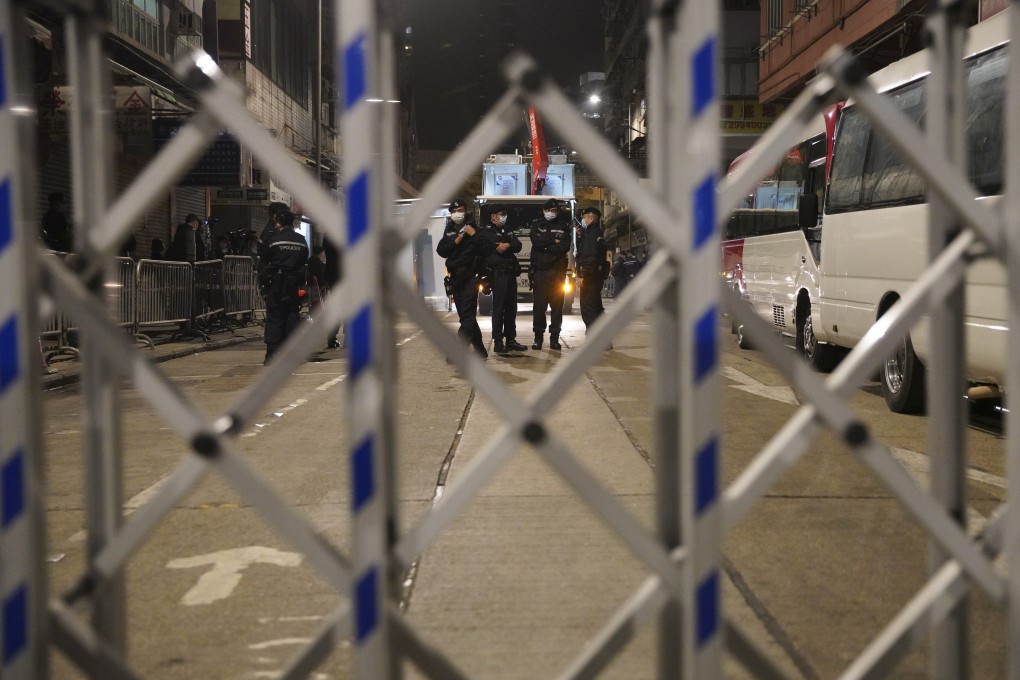 Police officers stand guard during an overnight lockdown in a Covid-19-hit section of Yau Ma Tei this week. Photo: Winson Wong