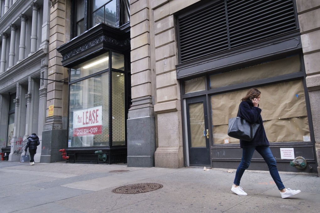 A pedestrian walks past closed retail stores in New York. Photo: EPA