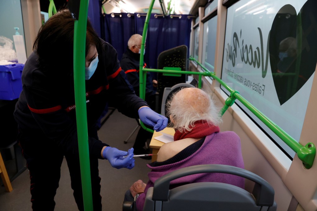 A firefighter administers a dose of the Pfizer/BioNTech Covid-19 vaccine to an elderly patient in Pevy, France. Photo: Reuters