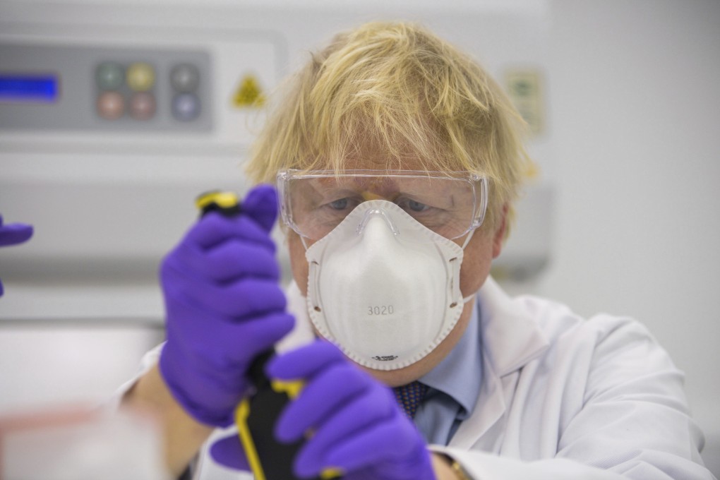 Britain’s Prime Minister Boris Johnson visits a biotechnology laboratory in Livingston, Scotland on Thursday. Photo: AP