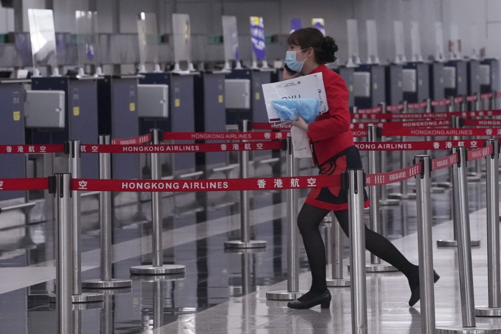 A Hong Kong Airlines staff member works at the carrier’s check-in counters at Hong Kong International Airport in December. Photo: Felix Wong