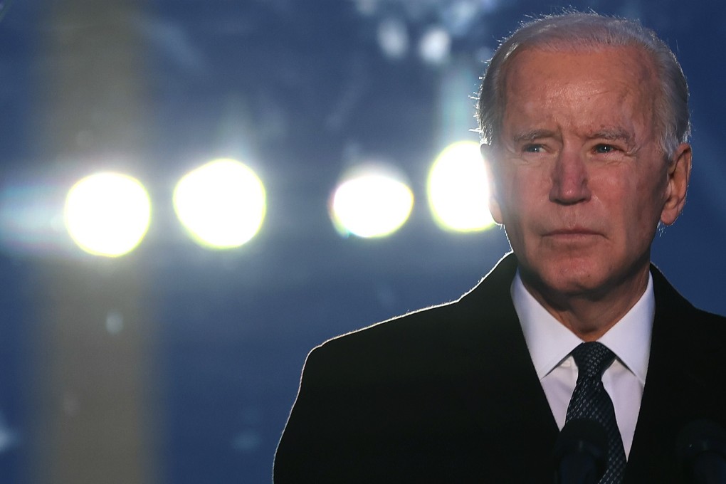 Joe Biden attends a memorial service for the nearly 400,000 American victims of the coronavirus pandemic at the Reflecting Pool in front of the Lincoln Memorial on January 19. Photo: Getty Images/AFP