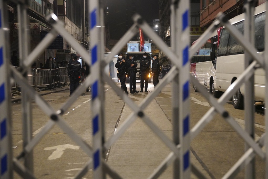 Police officers stand guard during an overnight lockdown in Yau Ma Tei. Photo: Winson Wong