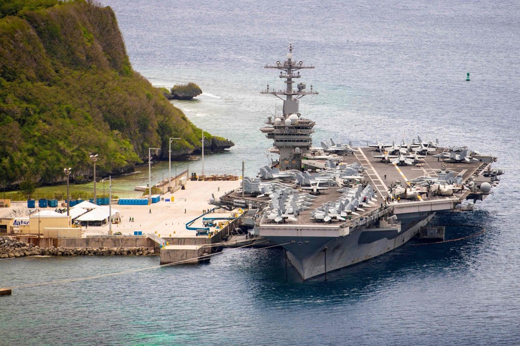 The USS Theodore Roosevelt (pictured at a naval base in Guam last year) monitored the activity of the PLA flights over the South China Sea, the US Navy said. Photo: AFP
