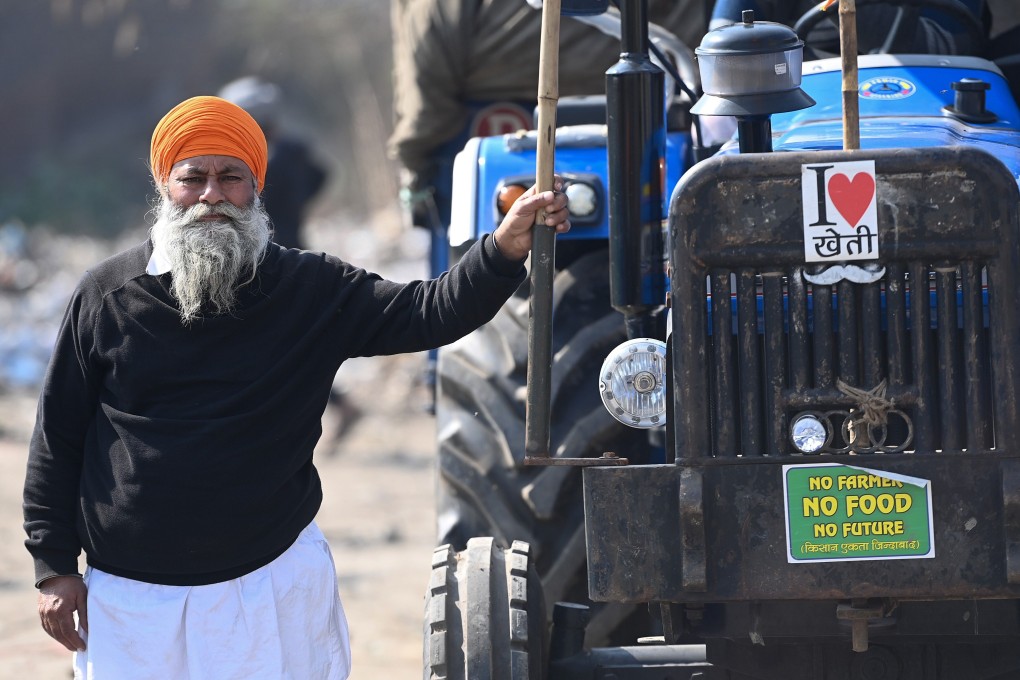 A farmer stands next to his tractor during an ongoing protest against the central government's recent agricultural reforms. Photo: AFP