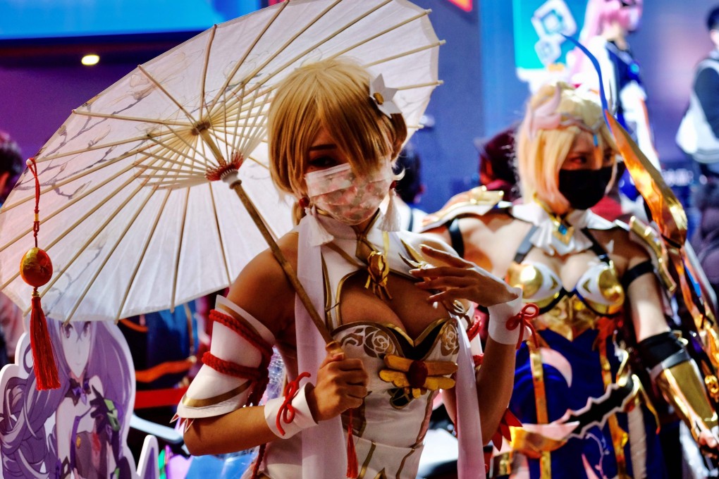 Cosplayers pose for photographs during a game show. Some Japanese cosplayers have called for a framework to obtain copyright holders’ permission for costumes. Photo: AFP