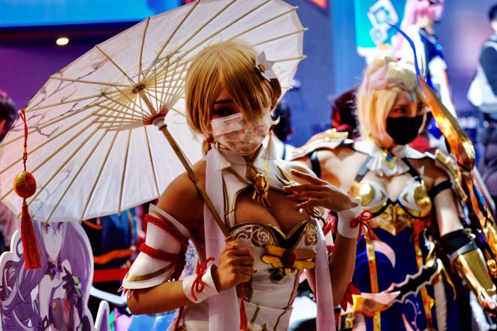 Cosplayers pose for photographs during a game show. Some Japanese cosplayers have called for a framework to obtain copyright holders’ permission for costumes. Photo: AFP
