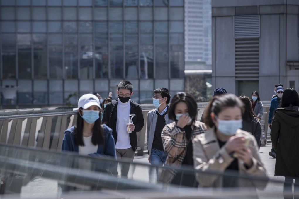 Pedestrians at the Lujiazui Financial District in Shanghai on Friday, March 20, 2020. Photo: Bloomberg