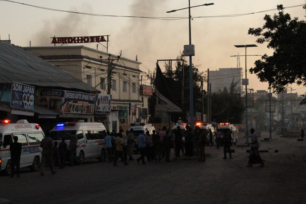 Ambulances attend the site where a bomb exploded in Mogadishu, Somalia, on Sunday. Somali police say the al-Shabab jihadist group claims responsibility. Photo: AFP