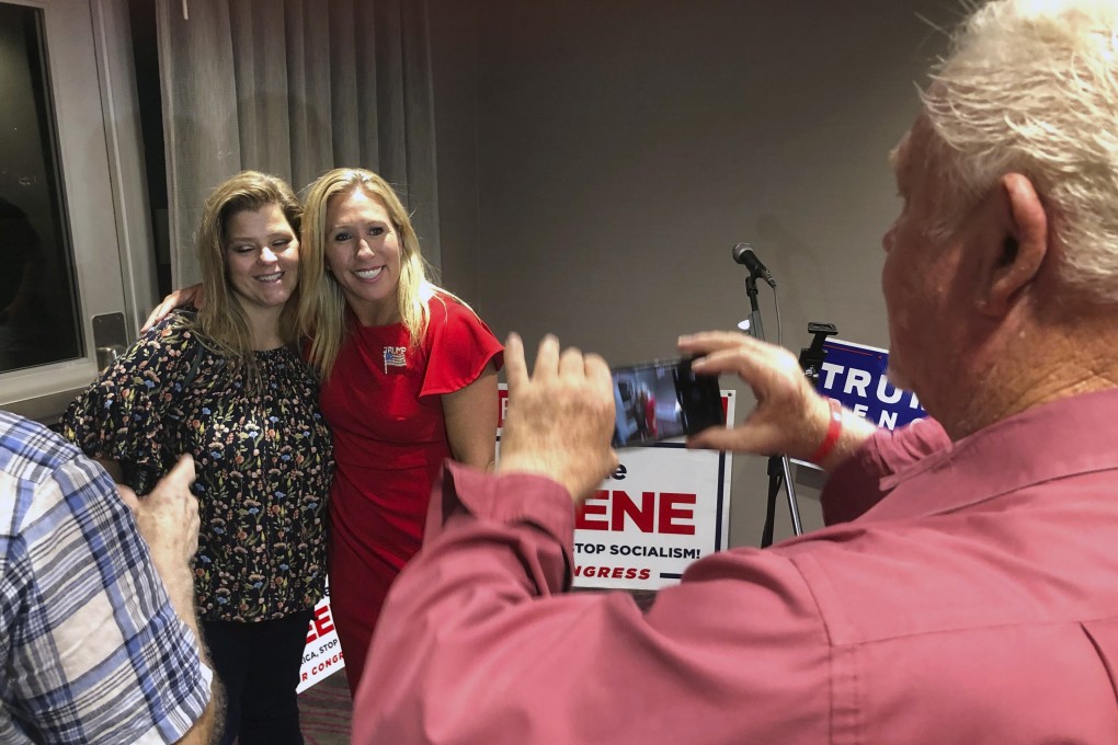 Supporters take photos with Marjorie Taylor-Greene, right, on August 11, 2020, in Rome, Georgia. Despite promoting racist videos and adamantly supporting the far-right QAnon conspiracy theory, Taylor-Greene won the election for northwest Georgia's 14th Congressional District. Photo: AFP