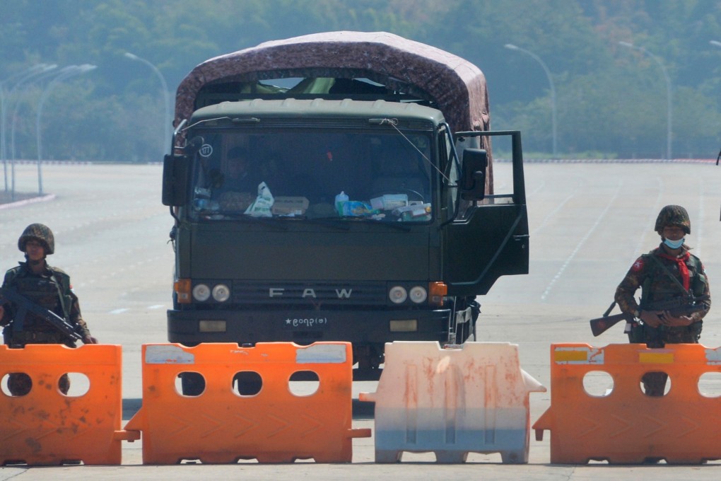Soldiers stand guard on a blockaded road to Myanmar’s parliament in Naypyidaw on Monday after the military detained the country’s de facto leader Aung San Suu Kyi and the country’s president in a coup. Photo: AFP