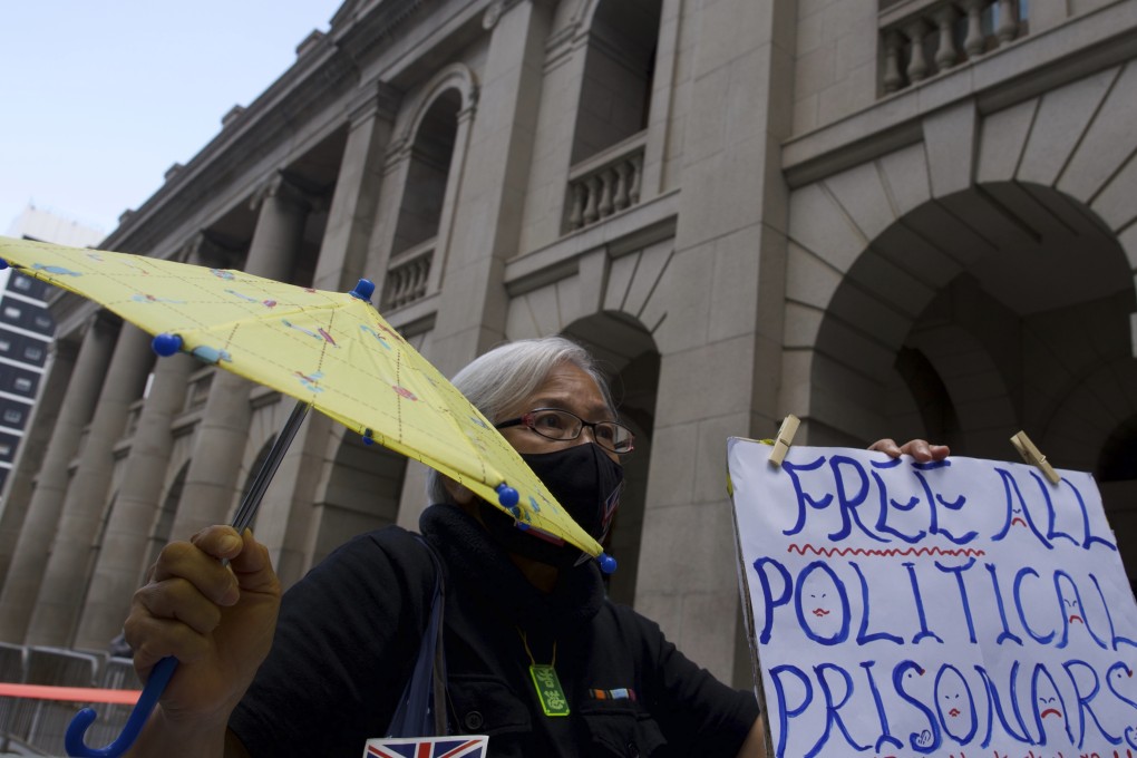 A protester displays a placard to support democracy advocate Jimmy Lai outside Hong Kong‘s Court of Final Appeal. Photo: AP
