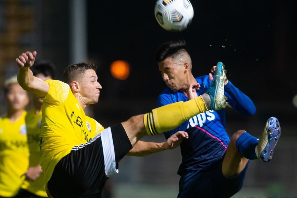 Kitchee defender Ho Chun-ting (in blue) tries to stop Lee Man forward Serii Shapoval in the Hong Kong Premier League. Photo: HKFA