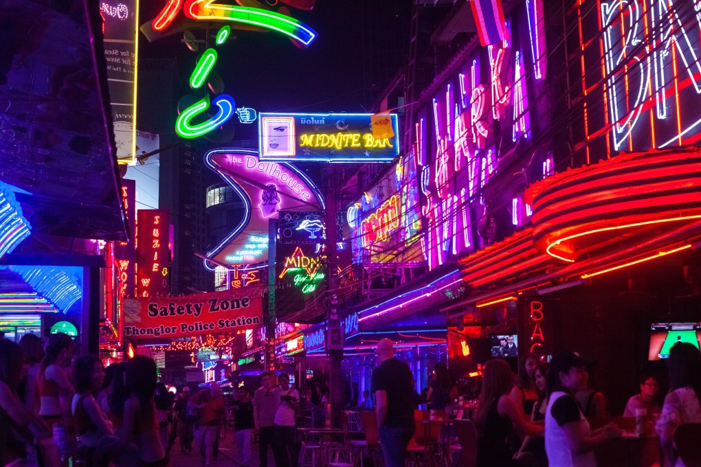 The nightlife and characters of places such as Soi Cowboy (pictured), a street in Bangkok’s red light district, has given expat crime writers inspiration for their colourful stories. Photo: Getty Images
