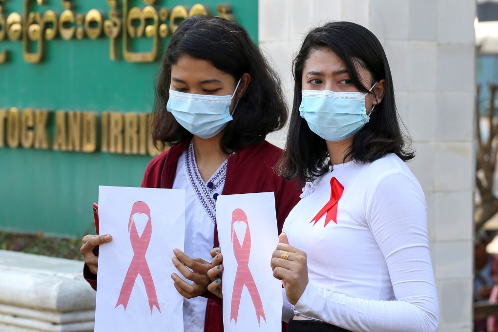 Government staff wearing red ribbons pose during a protest against the coup that ousted elected leader Aung San Suu Kyi in the capital, Naypyidaw, on Thursday. Photo: Reuters