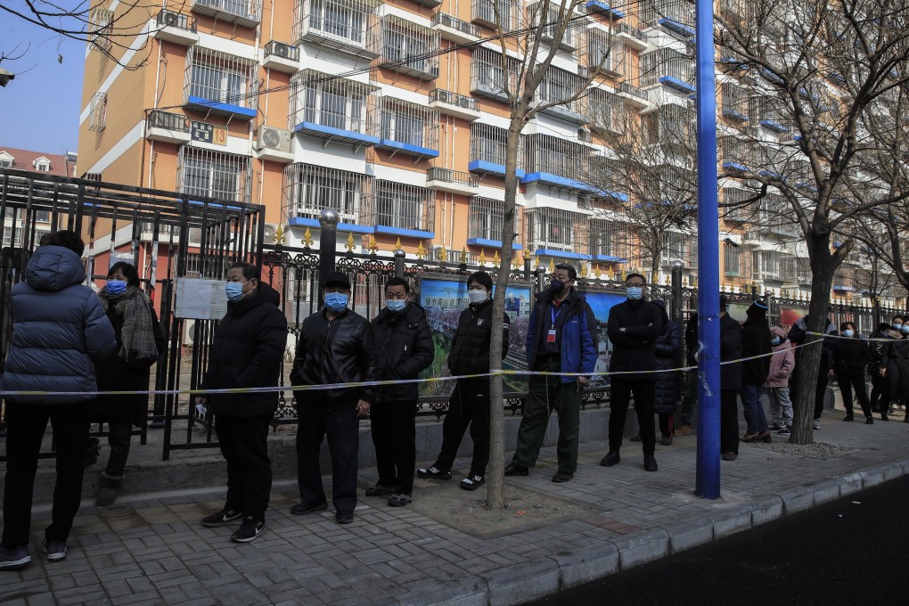 Local residents line up for mandatory coronavirus testing in Daxing district, Beijing, last month. Photo: EPA-EFE