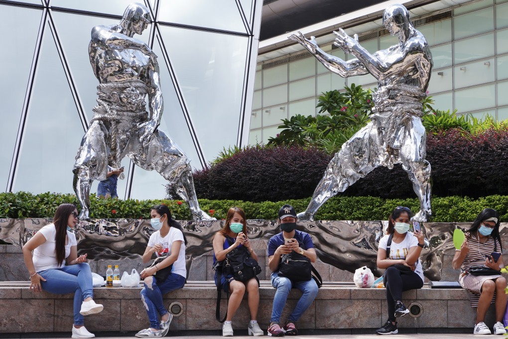 Domestic workers gather outside Exchange Square in Central during Hong Kong’s third wave of the coronavirus last summer. Photo: Robert Ng