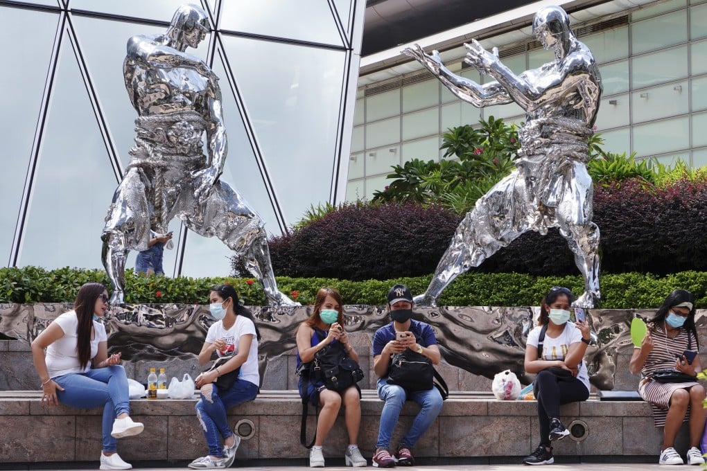 Domestic workers gather outside Exchange Square in Central during Hong Kong’s third wave of the coronavirus last summer. Photo: Robert Ng