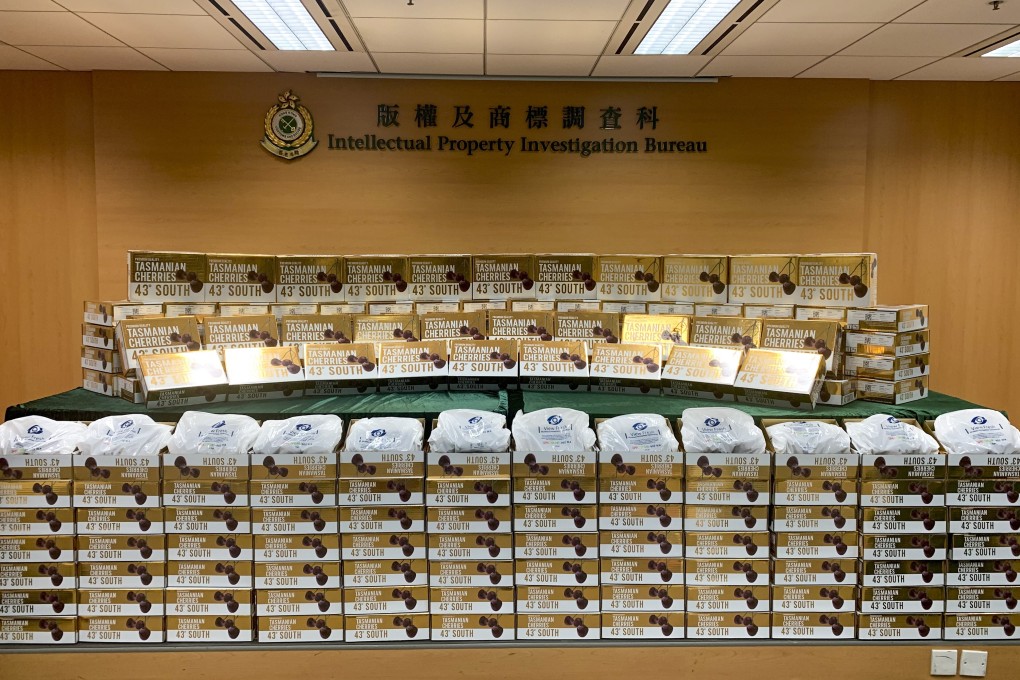 Customs officials display the nearly 200 boxes of fraudulently branded cherries seized in a raid on Thursday. Photo: Handout