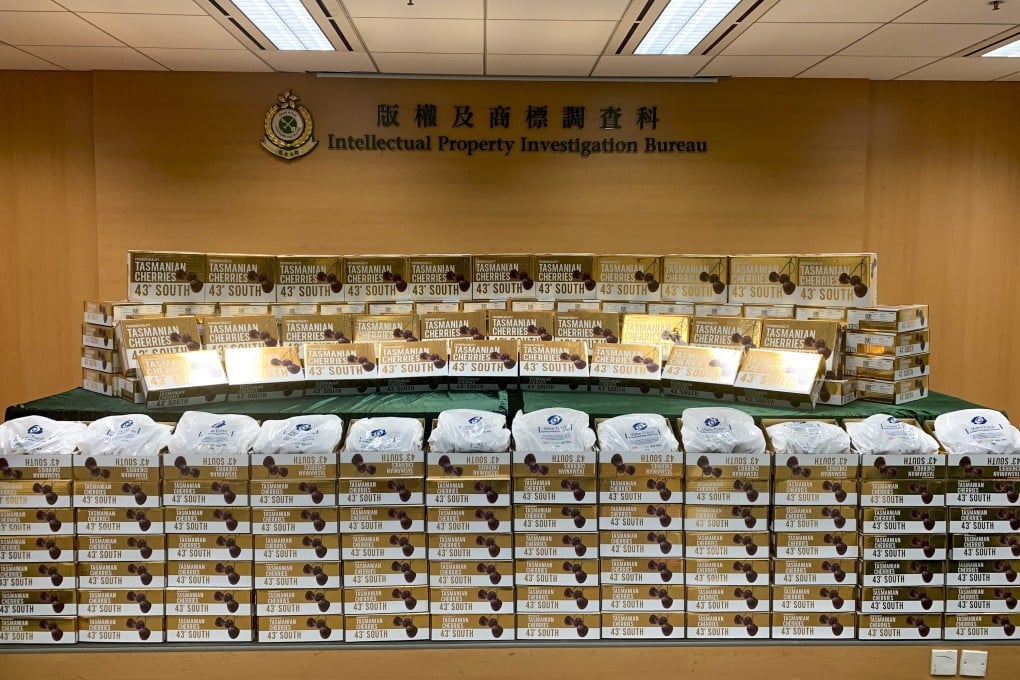 Customs officials display the nearly 200 boxes of fraudulently branded cherries seized in a raid on Thursday. Photo: Handout