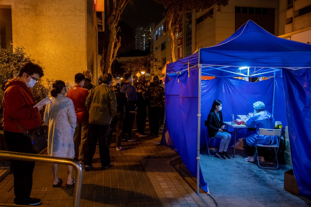 Residents wait in line for Covid-19 tests outside a building under lockdown in Laguna City, a residential estate in Kwun Tong, Hong Kong, on January 31. Photo: Bloomberg