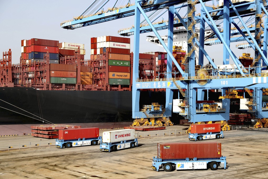 Automated vehicles move shipping containers in a container port in Qingdao in eastern China’s Shandong province on January 12. Photo: Chinatopix via AP
