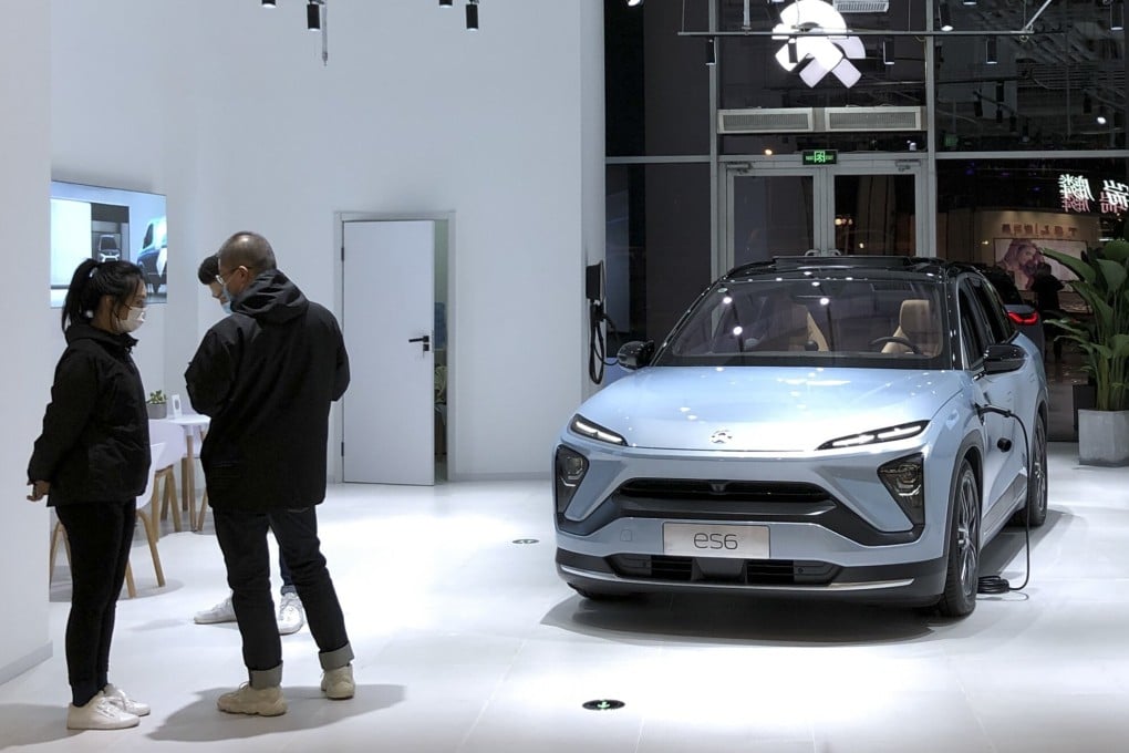 Potential customers chat near a NIO ES6 electric vehicle in Beijing, on November 28, 2020. Despite rapid growth, electric vehicles still make up only around 5 per cent of China’s car market. Photo: VCG via Getty Images