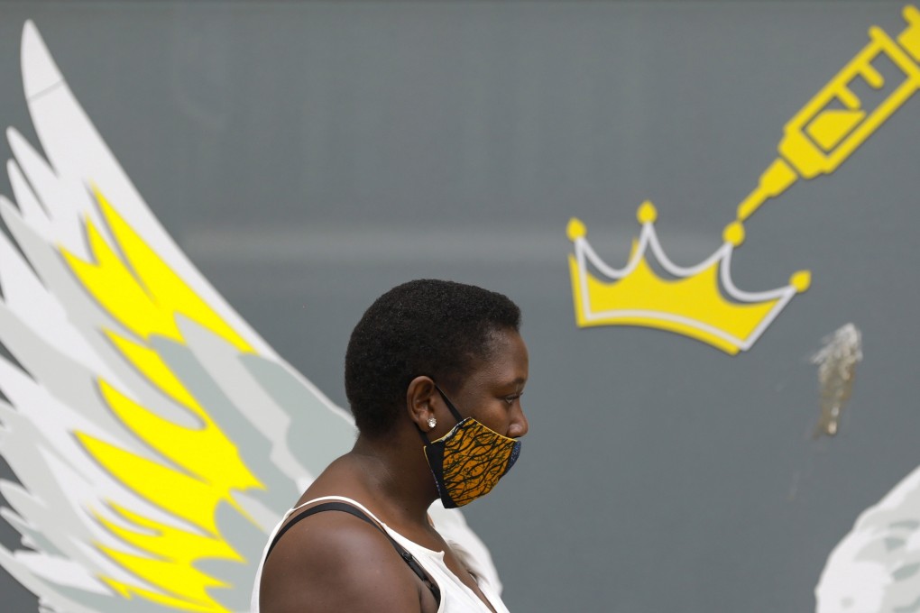 The Covax Facility, a WHO-led partnership to deliver equitable access to Covid-19 vaccines in poorer countries, says it is on track to provide 2 billion doses or more. Pictured is a woman walking past a mural in Cape Town, South Africa, on January 21. Photo: AP