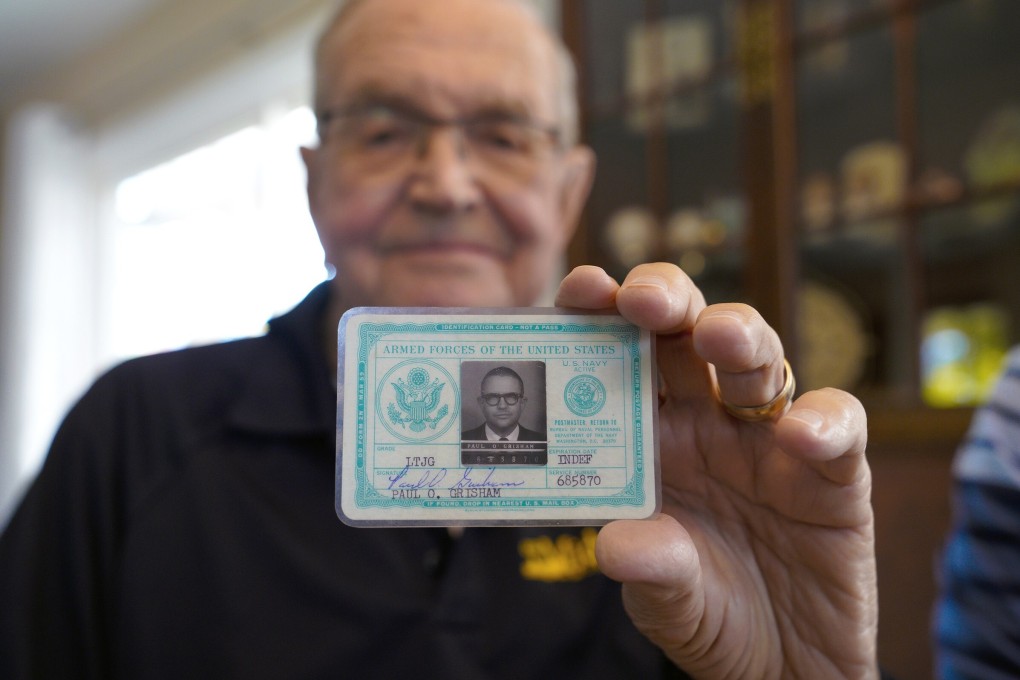 Paul Grisham holds his 1968 Navy ID card at his home in the San Carlos neighbourhood of San Diego, California on Wednesday. Photo: The San Diego Union-Tribune via AP