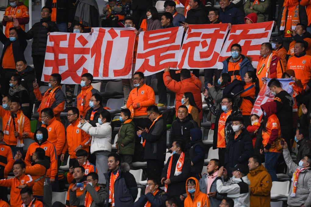 Shandong Luneng fans hold up signs in their match against Jiangsu Suning in December. Photo: Xinhua