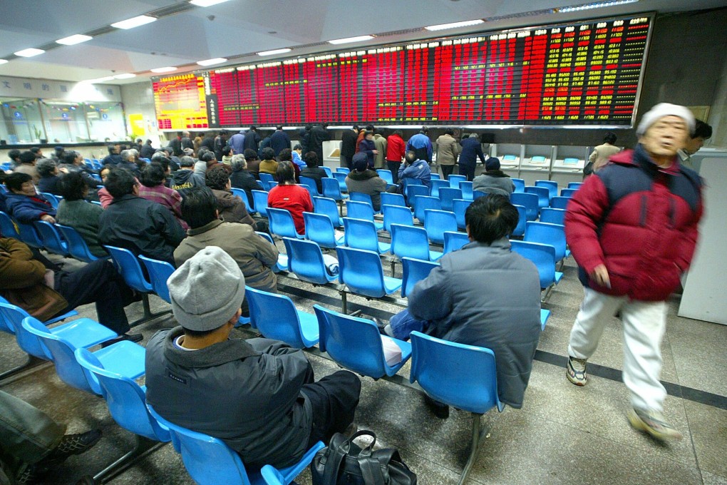 Retail investors watch stock prices at the Shanghai Stock Exchange. Will the Lunar New Year holiday stem the cash inflows into Hong Kong markets? Photo: AFP