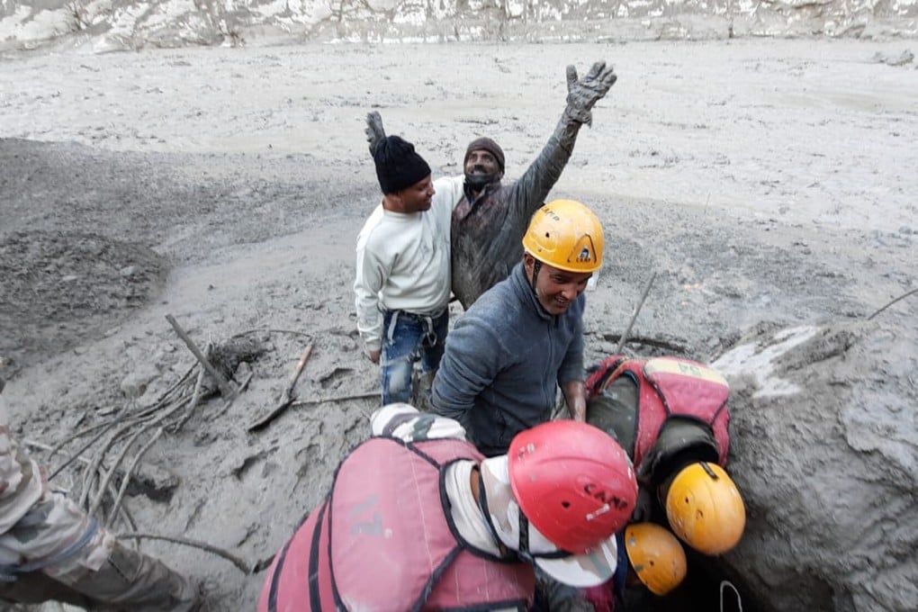 A hydropower plant worker raises his arms in joy after he was pulled out from beneath the ground during rescue operations after a portion of Nanda Devi glacier broke off in the Tapovan area. Photo: AP