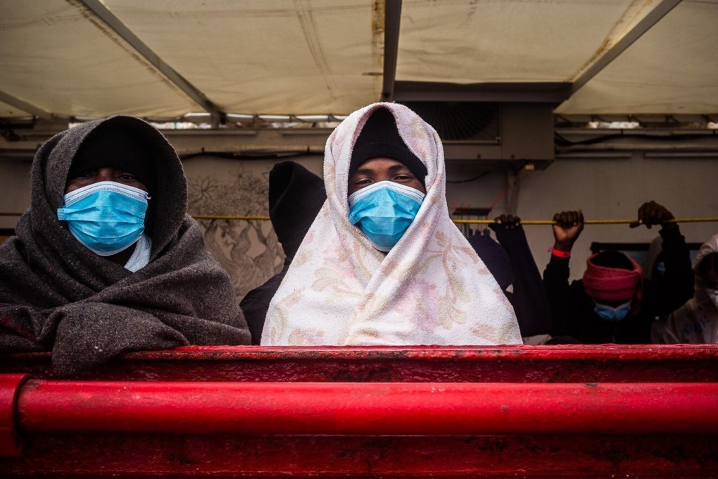 Migrants stand on the deck of the Ocean Viking rescue ship in the Mediterranean Sea on Sunday. Photo: Hippolyte / SOS Mediterranee via AP