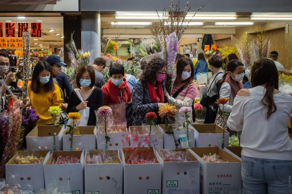 Shoppers browse at a flower market ahead of the Lunar New Year, in the Mong Kok area of Hong Kong on February 6. The city has been attempting to curb a fourth wave of Covid-19 infections with targeted lockdowns that have seen authorities cordon off an area and restrict movement until residents receive negative results. But these will be put on hold during the festive days. Photo: Bloomberg