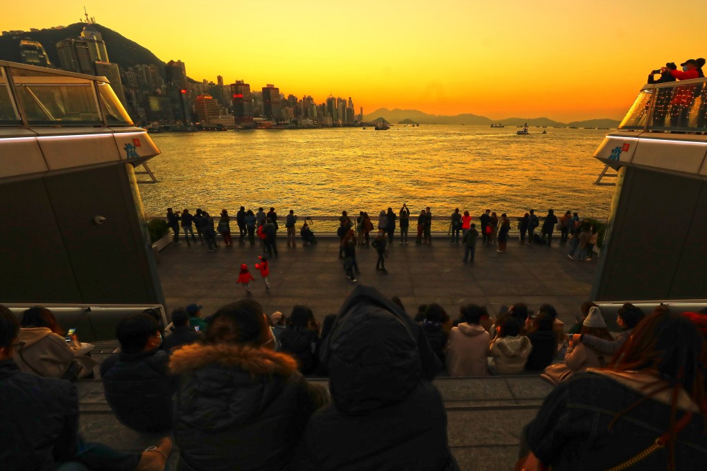 People gather to watch the last sunset of 2020 from Ocean Terminal, Harbour City, Tsim Sha Tsui, on New Year’s Eve in Hong Kong. Photo: Dickson Lee