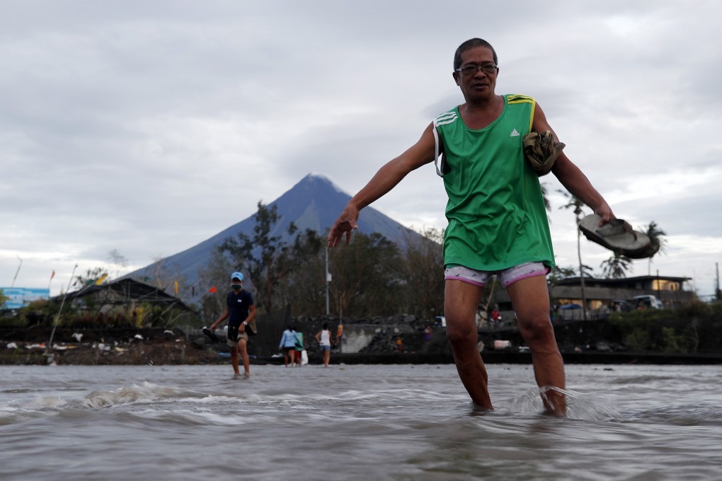 Villagers wade through floodwaters brought on by Typhoon Goni in Legaspi city, the Philippines, in November. Typhoon Goni left 20 people dead and affected two million people in the country. Photo: EPA-EFE
